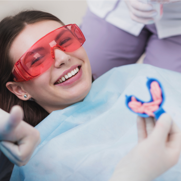 Dental professional applying fluoride varnish to teeth